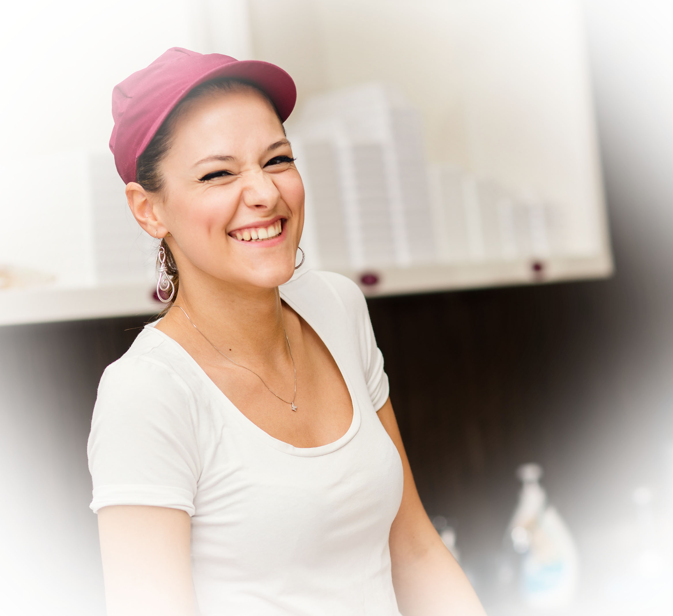 Young laughing saleswoman portrait inside ice cream shop.